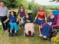 Wonder Woman accepts cheque from care home