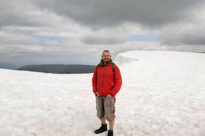 Owen at the peak of Ben Nevis in the snow last June 