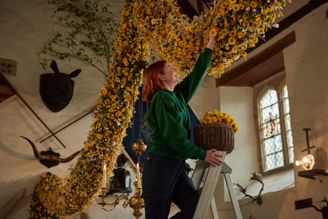 Last few dried flowers being placed in this year's garland Image Credit National Trust 