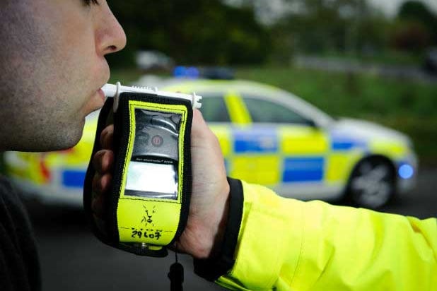 Man blowing into a breath test machine