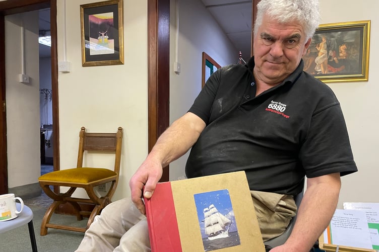 Philip Chatfield, with a book about Sister Assumpta, the ship whose wreck he narrowly survived.