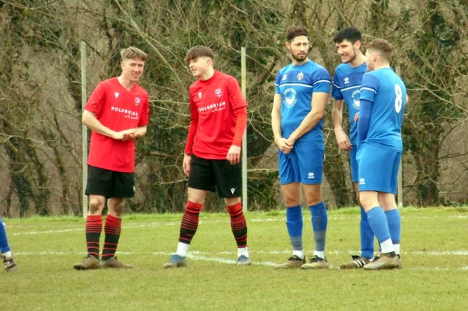 Bude debutant Dave Youldon (left), James Dart (centre) and Harry Hopcroft have a chat as they prepare to defend a Mullion free-kick.