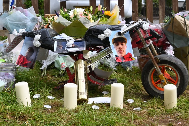 A floral tribute left in the garden of Jamie Lane by his sister