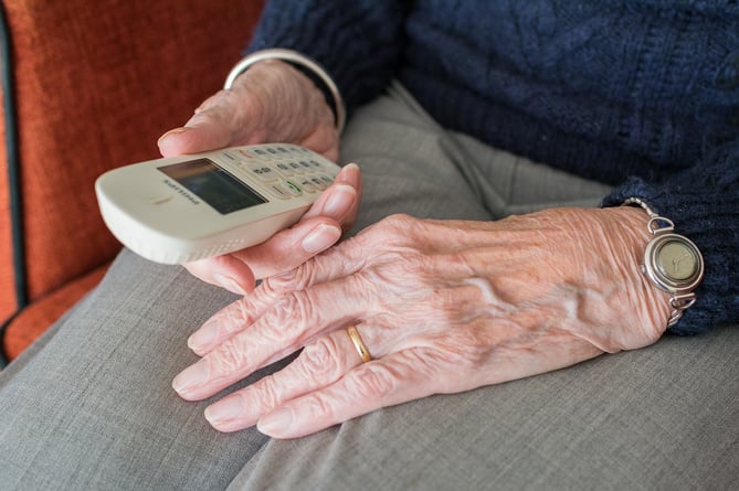 File image of an elderly person holding a telephone