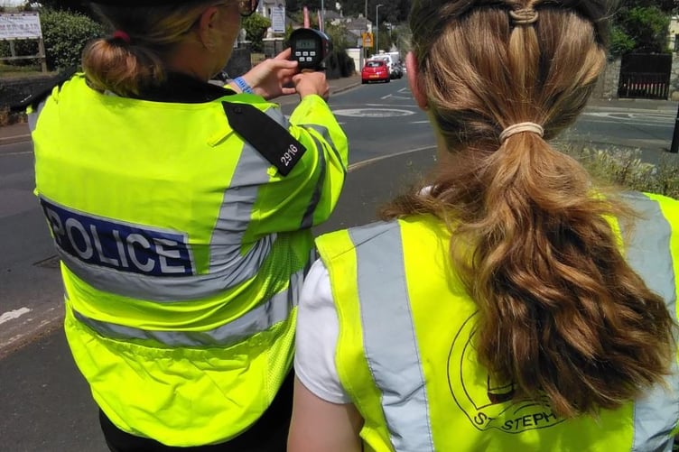 Police officer showing youth how a mobile speed camera works
