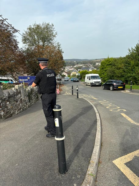 A police officer outside a school in Bodmin