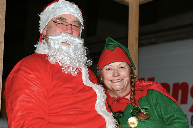 Father Christmas arrives along with his elf