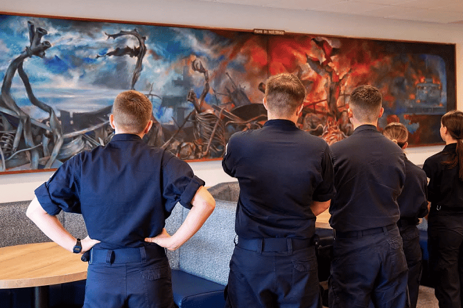 HmS Raleigh trainees admire the recently-found artwork.
