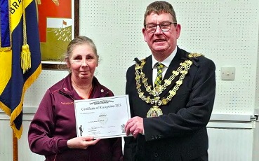 Lynette Smith being presented with a certificate of recognition by the mayor of Bodmin Cllr Phil Cooper