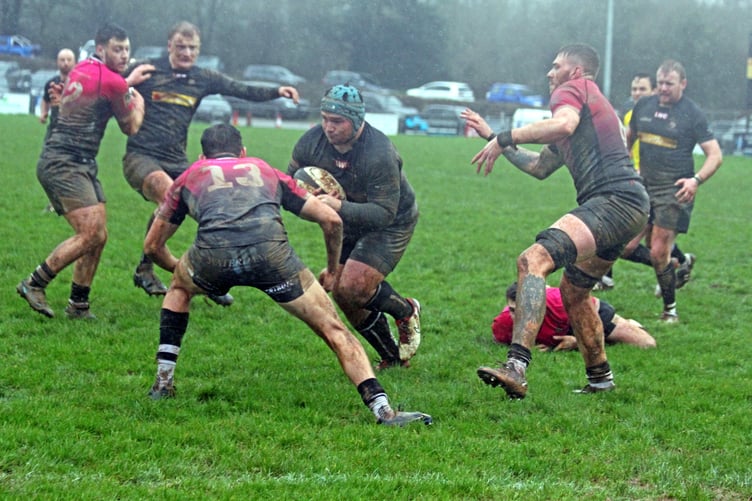 Launceston's Brandon Rowley runs at Brixham centre Louie Drennan during Saturday's clash at Polson Bridge.