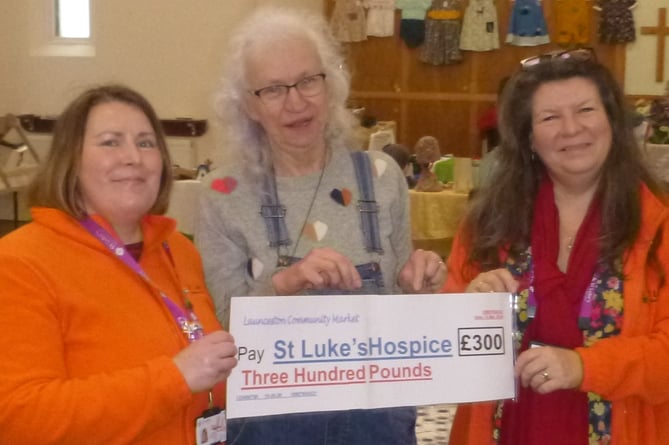Sarah Wallis and Nina Wearne from St Luke's receiving a cheque from Maryanne Parson from the Launceston Community Market