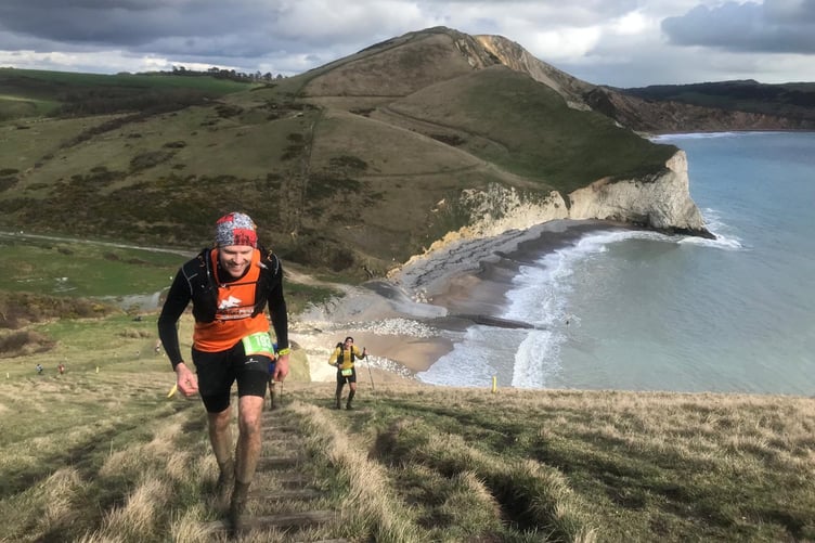 Simon Teagle running along the Jurassic Coast in training for the Cornish coastal challenge