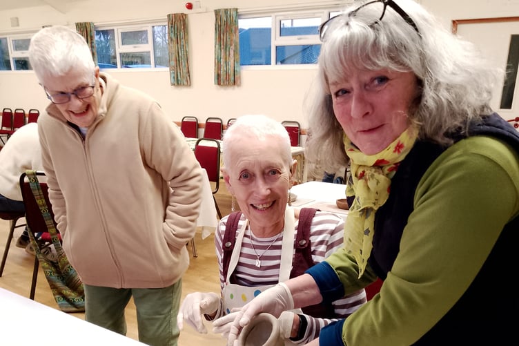 Gill Dubey showing Maxine Towl how to shape her pot during the St Giles Women's Guild meeting