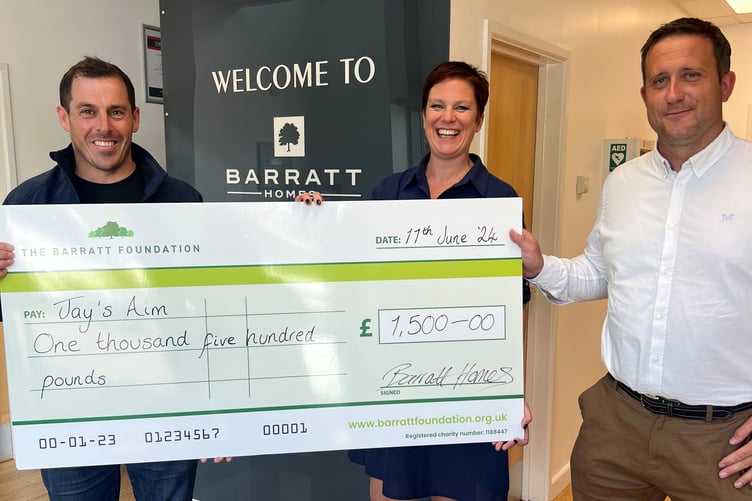 Barratt David Wilson Homes Exeter's sales director Nicki Reid and contracts manager Dan Noakes present a cheque to Jay’s Aim charity manager Dan Osborne
