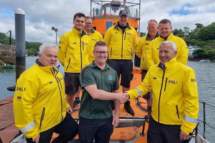 Aiden Libby, of Launceston-based Horizon Architectural Glazing, with coxswain Jonathan Pritchard and other members of the lifeboat crew. Picture: Fowey RNLI