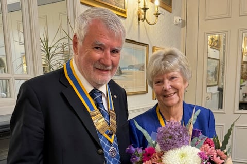 Bude Rotary president Martin Yeo presents Inner Wheel president Di McDougall with flowers
