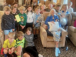 School children help resident celebrate 100th birthday