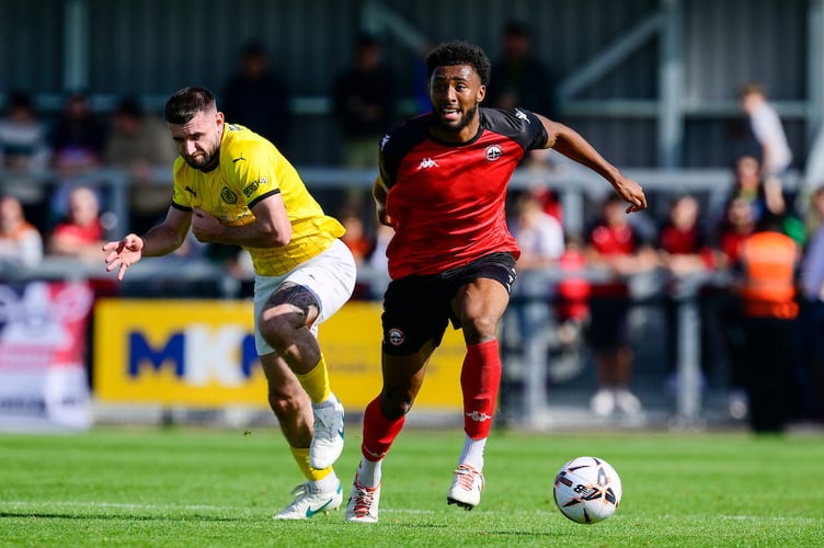 Pharrell Johnson of Truro City holds off Danny Newton of Brackley Town during the Emirates FA Cup 2nd round qualifying tie match between Truro City and Brackley Town at Truro Sports Hub on 14 September 2024  Photo: Phil Mingo/PPAUK