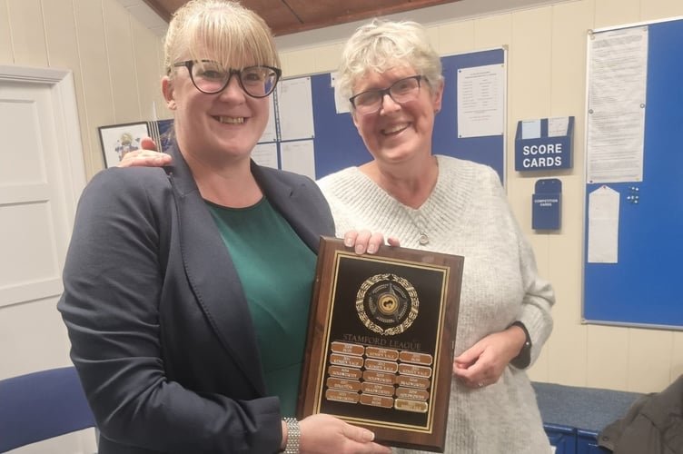 Dunheved lady captain Claire Fishleigh receives the Stamford League trophy from Bude's Jenny Horncastle. Picture: Dunheved Bowling Club