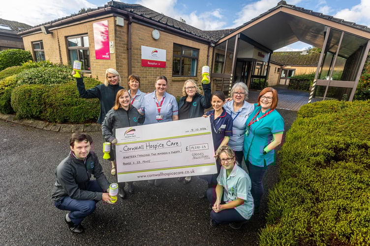 Staff from Coodes Solicitors present a giant cheque to Cornwall Hospice Care.