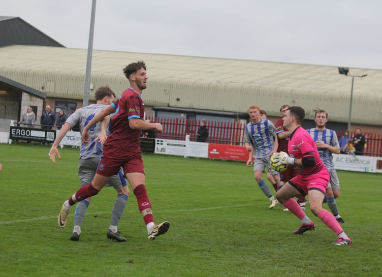 Holsworthy goalkeeper Ryan Chadwick, pictured with the ball at Launceston back in November, made two crucial stops at Burngullow Park. Picture: Paul Hamlyn