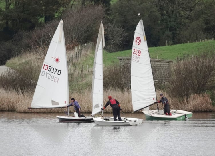 Bob Sampson, Dave Perrett and Nathan Pollard push out their booms to catch any breath of wind there might be. Picture: Mandy Pollard