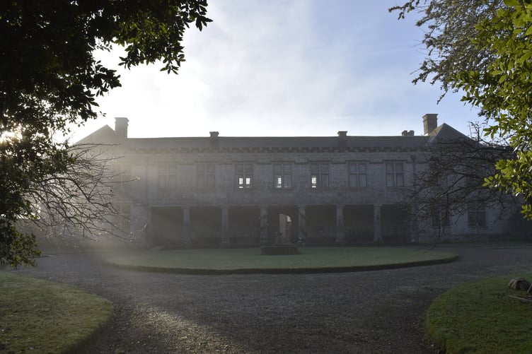 The house in morning light with Christmas decorations on the columns at Godolphin, Cornwall.
