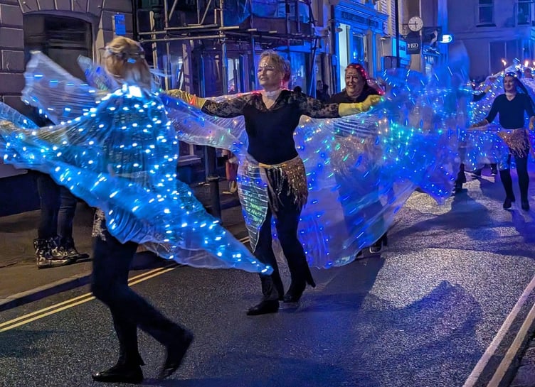 Dancers with sparkling cloaks light up the night sky. Picture: Mike Smart.