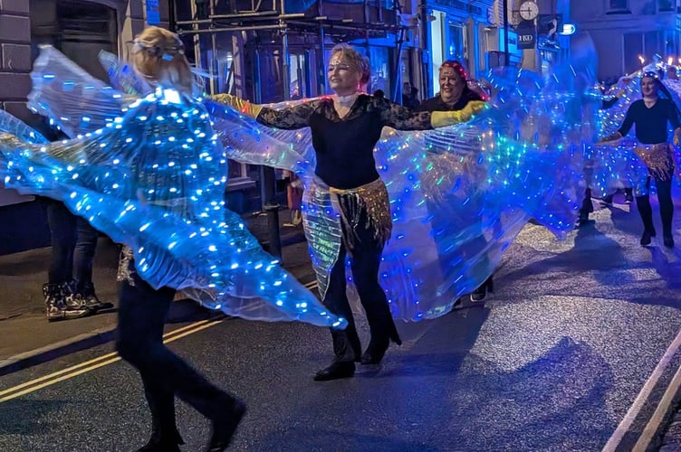 Dancers with sparkling cloaks light up the night sky. Picture: Mike Smart.