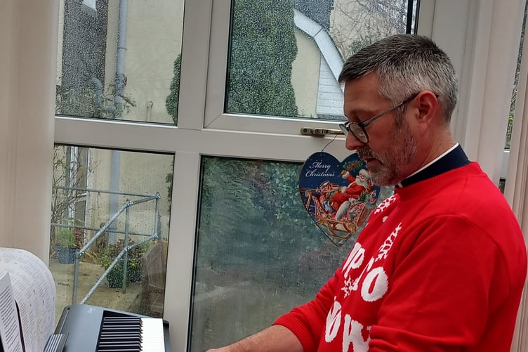 THE Rev Tim Wilkinson on the keyboard during one of the carol service visits