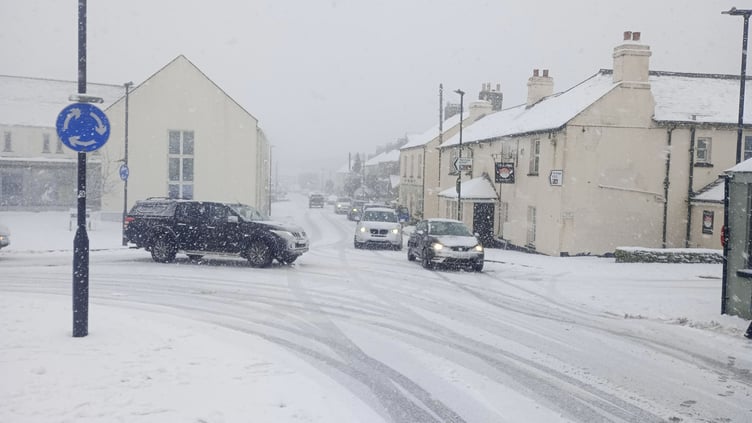 Traffic gingerly negotiating the roads in Princetown this afternoon. Pictured by Miles Fowler