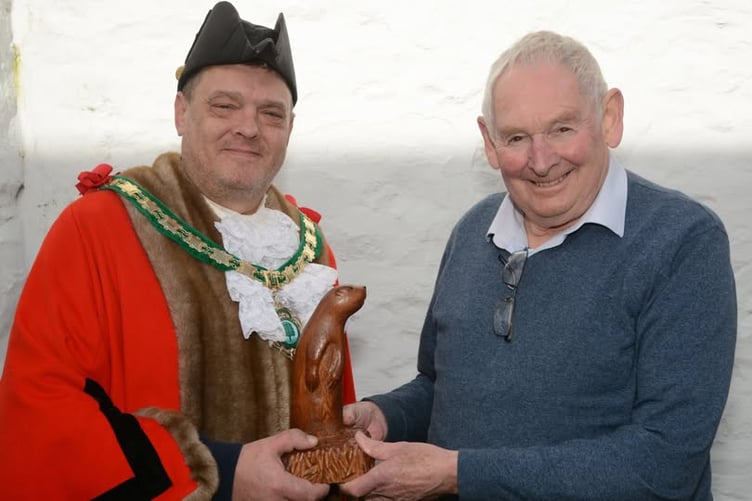 Cllr Nigel Kenneally, the mayor of Holsworthy being presented with the otter carving by Chris Osborne. (Picture: Holsworthy Town Council)