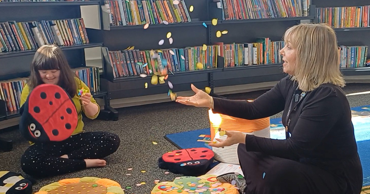 Molly and Lotti read a sensory story at Camborne library