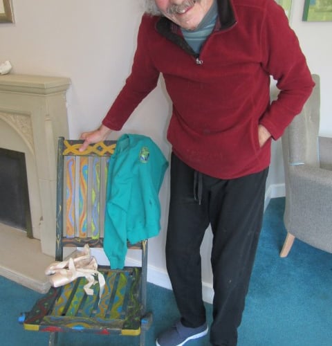 Artist in residence at Kernow House Alan, painting and displaying the finished chair