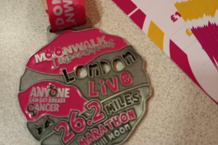 The medal Sandy Smith and her husband Martin were awarded for having completed the MoonWalk, a full marathon of 26.2 miles.