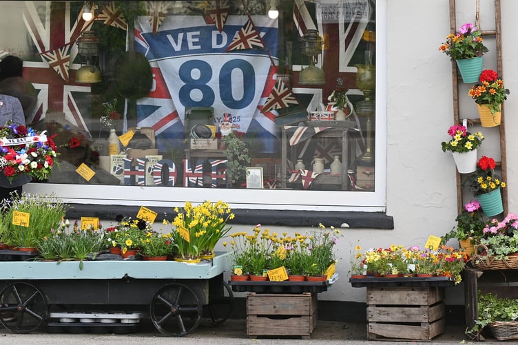 Proudly standing alongside her fantastic Window Display decorated for the VE Day Celebrations in Delabole is Elaine Reynolds of Flowers From Bruallen (Picture: Adrian Jasper)