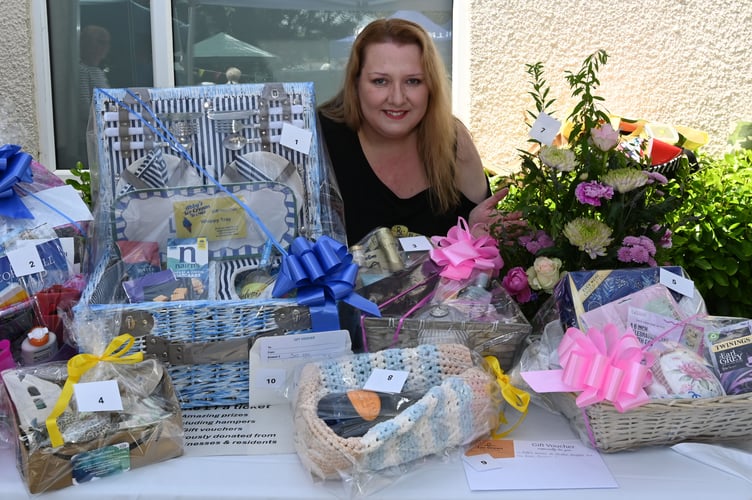 Lorraine Corrigan-Turner (Stratton Hospital League of Friends Trustee) along with the many prizes on offer in the raffle