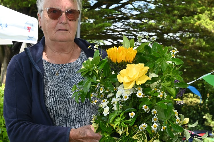 Chris Simmons (Stratton Hospital League of Friends Trustee) with one of the flower arrangements made by the patients at the hospital
