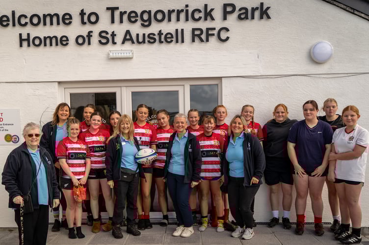 St Austell Girls receive a “soroptimist” rugby ball from Jennie Walker of Kernow Soroptimists.