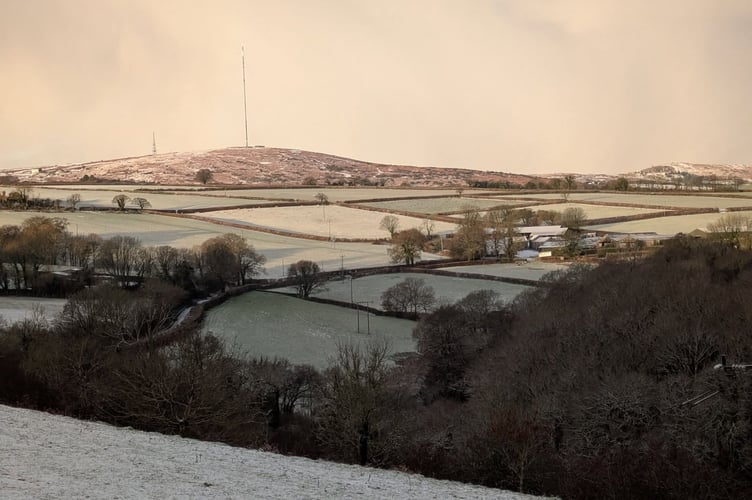 Snow on the field with Caradon Hill in the distance