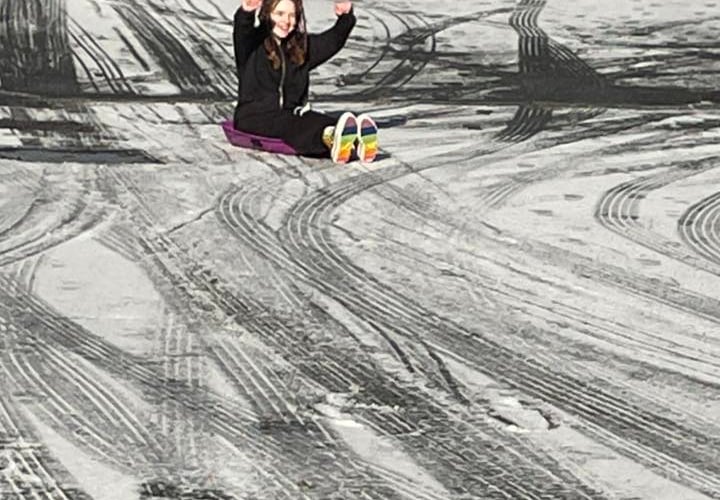 A youngster having fun in South East Cornwall with her sled