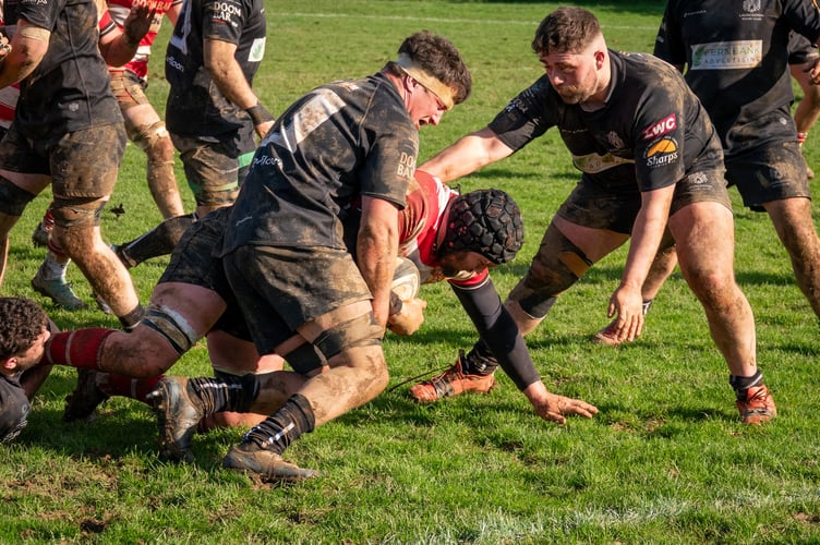 Launceston's George Bone (left) and Rory Mead compete to stop St Austell's Kyle Marriott from heading towards the try line at Polson Bridge
