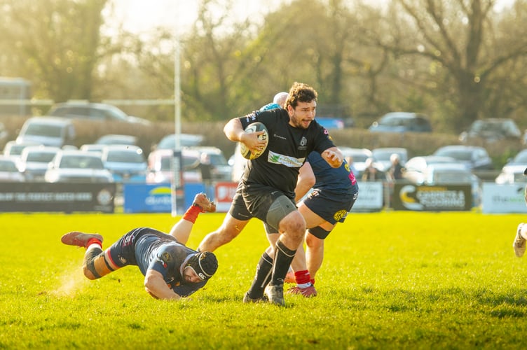 Launceston's Brandon Rowley slips off a Devonport Services tackle to score one of his side's tries at Polson Bridge (Picture: 