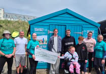 Swimmer makes waves raising hundreds for adaptive surfing charity