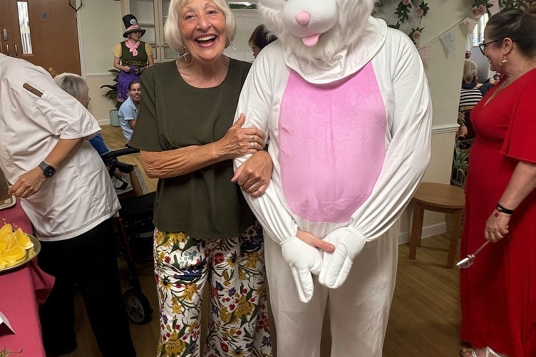 Community visitor Pam Martin was thrilled to have her photograph taken with the illusive White Rabbit, aka healthcare assistant Adam Stratton