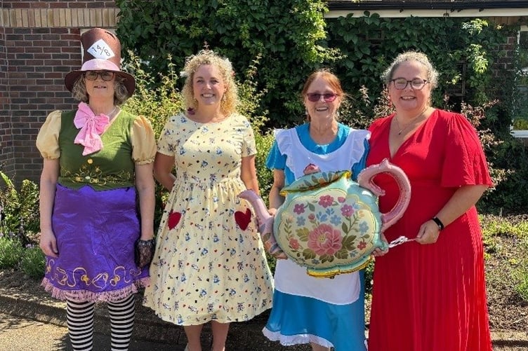 Anyone for a cup of tea? Prepared for the madness that was the Mad Hatter Tea Party at Deer Park Nursing Home, Holsworthy, are (from left) team leader Anne Finch. entertainer Emma Richardson, activities coordinator Alyce Barber and deputy manager Amanda Williams