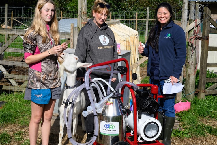 Norah, one of the goats, Karen,and Katie from DP Agri with the milking machine (Picture: Holsworthy Rotary Club)